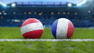 Soccer,Balls,With,Austria,And,France,Flags,On,Grass,Field