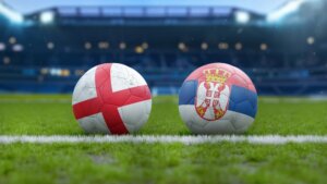 Soccer,Balls,With,England,And,Serbia,Flags,On,Grass,Field